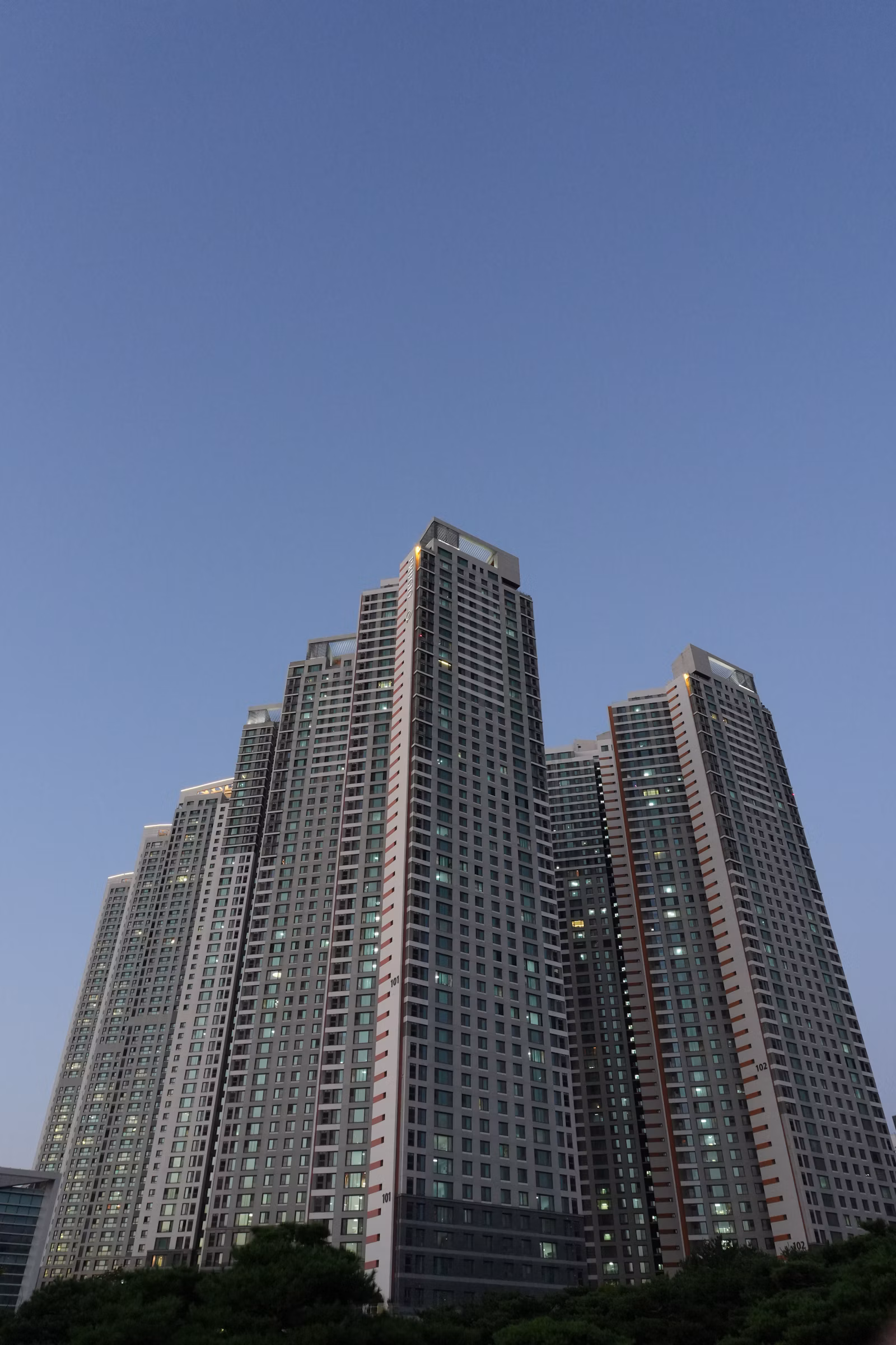 Tall residential apartment tower with rows of windows and balconies